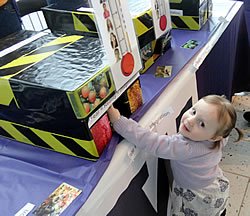 Photo: A brave toddler explores Associate Professor Lori Zoellner’s booth on fear at PAWS on Science at the Pacific Science Center.